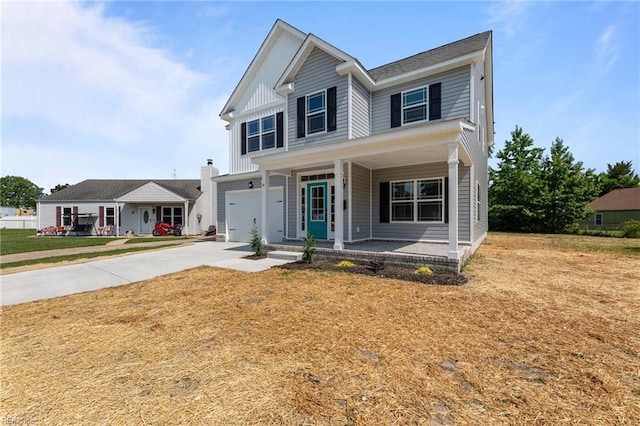 4 Roundtree Cir, Hampton, VA 23661 - view of front of property with a porch, concrete driveway, an attached garage, board and batten siding, and a front yard