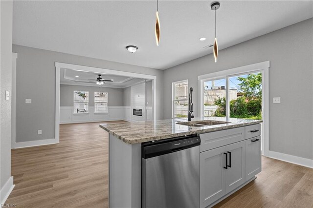 4 Roundtree Cir, Hampton, VA 23661 - kitchen featuring stainless steel dishwasher, light wood-type flooring, a center island with sink, light stone countertops, and hanging light fixtures
