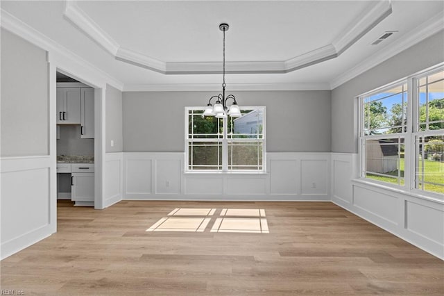 4 Roundtree Cir, Hampton, VA 23661 - unfurnished dining area with a raised ceiling, crown molding, a chandelier, a decorative wall, and light wood-style flooring