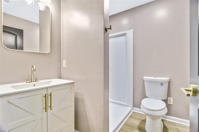 112 Atwell Ln, Hampton, VA 23669 - bathroom featuring toilet, vanity, wood finished floors, baseboards, and a shower