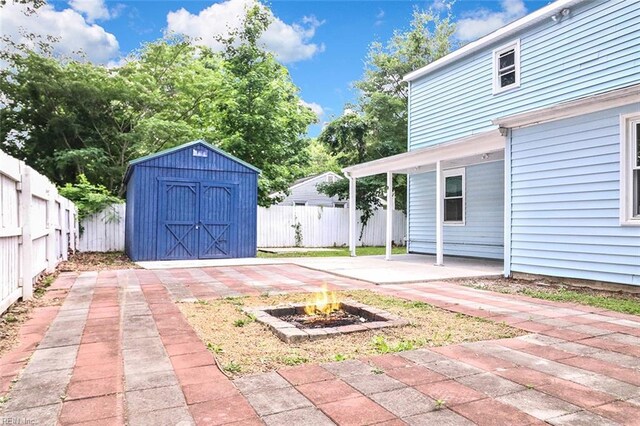 112 Atwell Ln, Hampton, VA 23669 - fenced backyard featuring an outdoor fire pit and a patio area