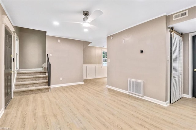 112 Atwell Ln, Hampton, VA 23669 - unfurnished living room featuring a barn door, wood finished floors, ceiling fan, stairs, and recessed lighting