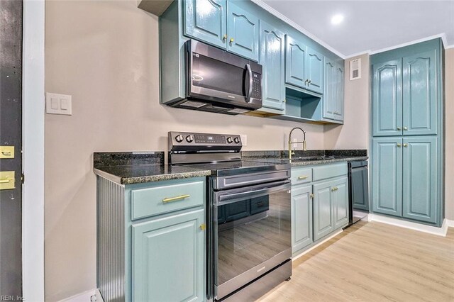 112 Atwell Ln, Hampton, VA 23669 - kitchen with appliances with stainless steel finishes, light wood-style flooring, a sink, baseboards, and dark stone counters