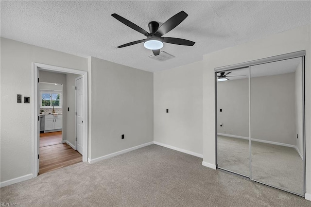 2920 Fetsch Pl, Virginia Beach, VA 23453 - unfurnished bedroom featuring carpet flooring, a textured ceiling, a closet, ceiling fan, and baseboards