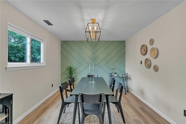 2920 Fetsch Pl, Virginia Beach, VA 23453 - dining area featuring a chandelier, light wood-type flooring, an accent wall, and baseboards