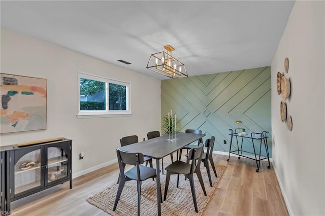 2920 Fetsch Pl, Virginia Beach, VA 23453 - dining area with light wood-style floors, a chandelier, baseboards, and an accent wall