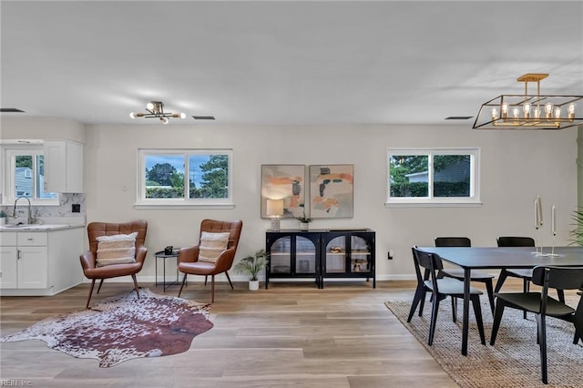 2920 Fetsch Pl, Virginia Beach, VA 23453 - dining room featuring a chandelier, light wood-style floors, and baseboards