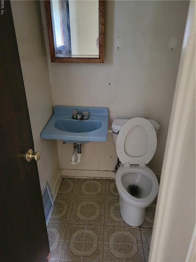 536 Longfellow Ave, Virginia Beach, VA 23462 - half bath with toilet and tile patterned flooring