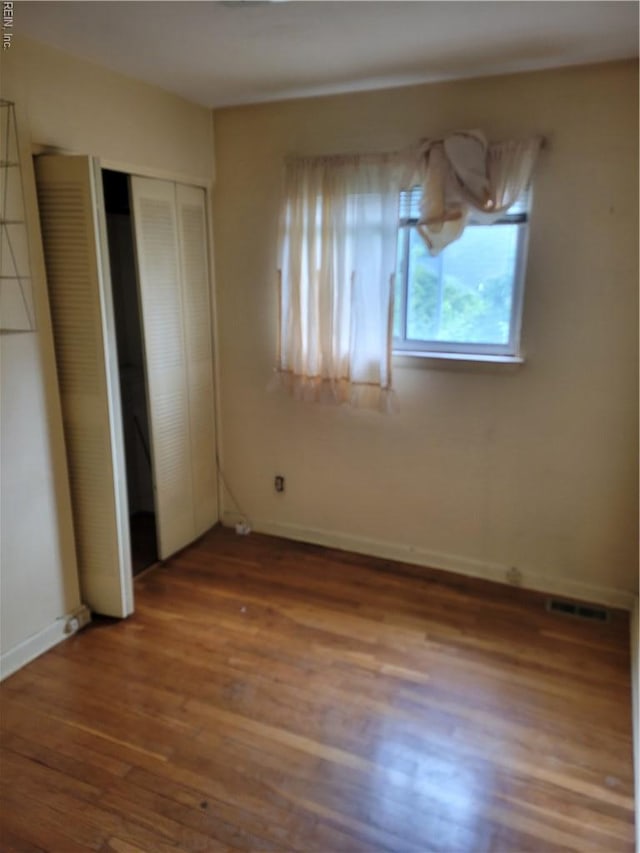 536 Longfellow Ave, Virginia Beach, VA 23462 - unfurnished bedroom with wood finished floors, a closet, and baseboards