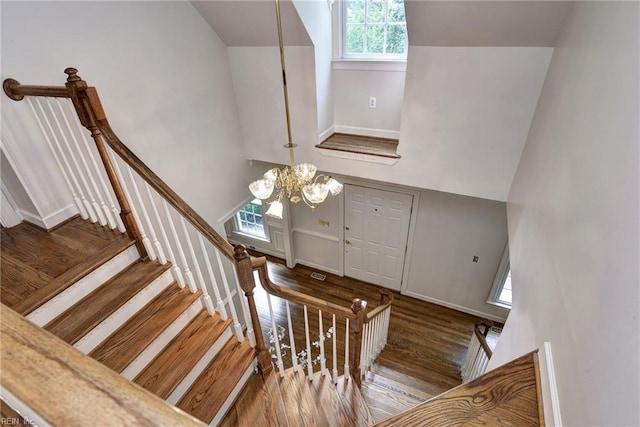 2116 Harpers Ml, Williamsburg, VA 23185 - stairway with wood finished floors, a chandelier, lofted ceiling, and baseboards