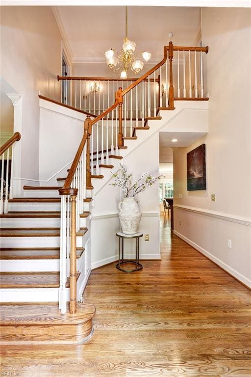 2116 Harpers Ml, Williamsburg, VA 23185 - stairs with wood finished floors, a chandelier, baseboards, a towering ceiling, and ornamental molding