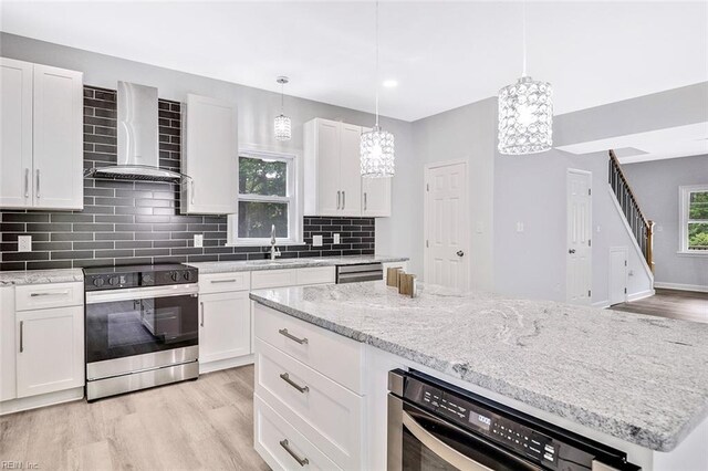 3502 Goodwin Neck Rd, Yorktown, VA 23692 - kitchen with appliances with stainless steel finishes, wall chimney exhaust hood, backsplash, light wood-type flooring, and recessed lighting