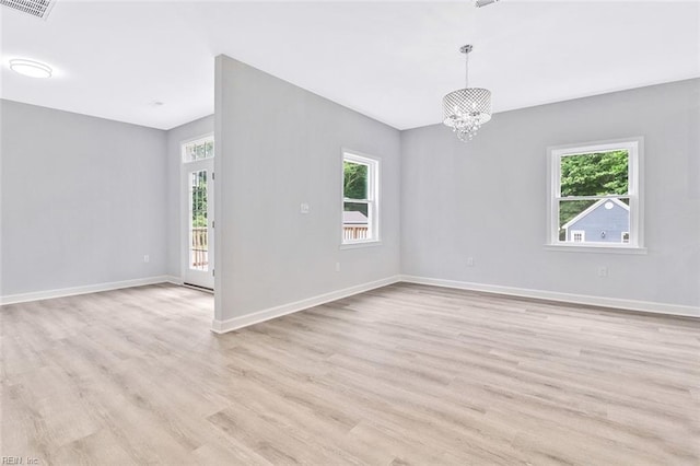3502 Goodwin Neck Rd, Yorktown, VA 23692 - empty room with a chandelier, light wood finished floors, and baseboards