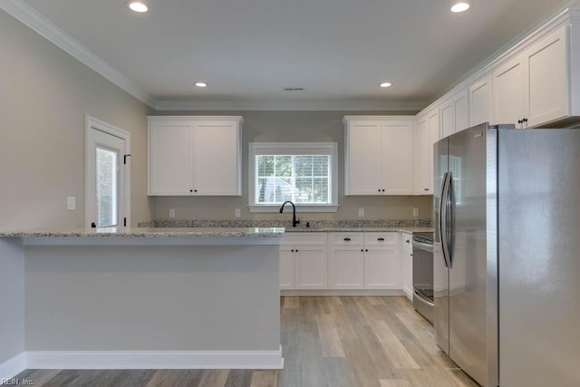 312 Bank St, Suffolk, VA 23434 - kitchen featuring appliances with stainless steel finishes, white cabinets, crown molding, light wood-type flooring, and light stone counters
