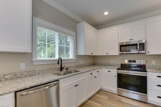 312 Bank St, Suffolk, VA 23434 - kitchen with appliances with stainless steel finishes, a sink, white cabinetry, ornamental molding, and light stone counters