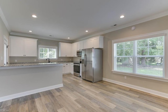 312 Bank St, Suffolk, VA 23434 - kitchen featuring stainless steel appliances, crown molding, white cabinetry, light wood finished floors, and a sink