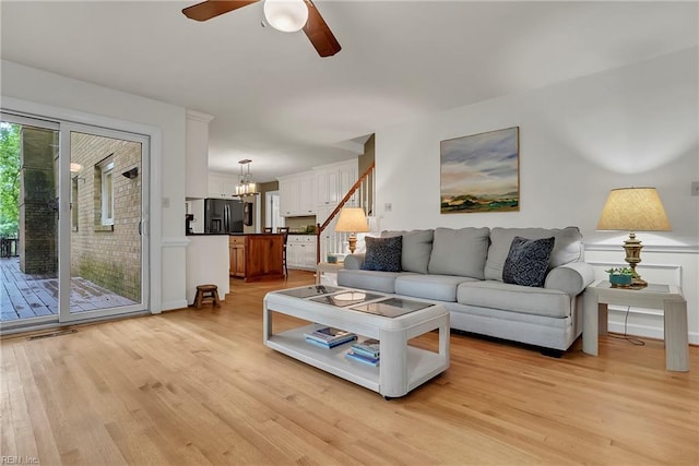 928 S Spigel Dr, Virginia Beach, VA 23454 - living room featuring light wood-style flooring, a ceiling fan, a chandelier, and stairs