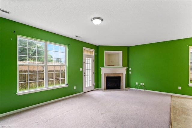 10 Musket Ln, Hampton, VA 23666 - unfurnished living room featuring carpet flooring, a fireplace with flush hearth, and a textured ceiling