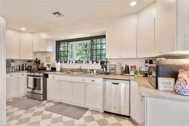 1301 Penguin Cir, Virginia Beach, VA 23451 - kitchen featuring appliances with stainless steel finishes, white cabinets, light floors, and recessed lighting