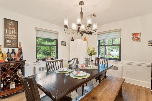 1301 Penguin Cir, Virginia Beach, VA 23451 - dining room featuring radiator heating unit, a chandelier, and wood finished floors