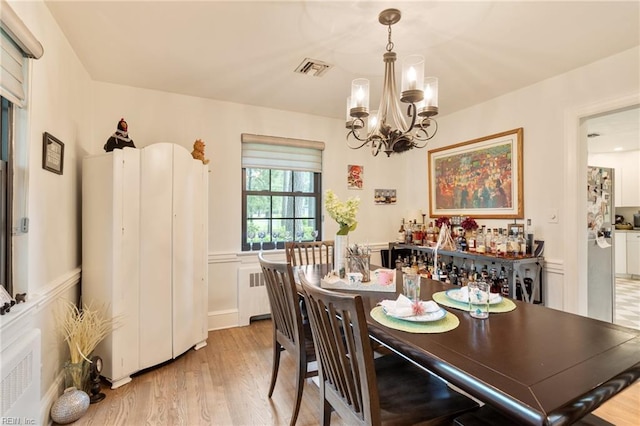 1301 Penguin Cir, Virginia Beach, VA 23451 - dining space featuring a chandelier, light wood-style floors, and radiator