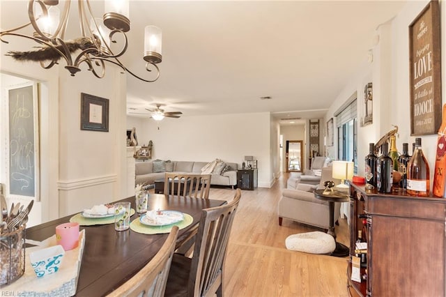 1301 Penguin Cir, Virginia Beach, VA 23451 - dining area with light wood-style floors, a chandelier, and a ceiling fan