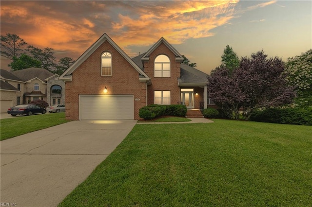 5308 Doral Woods Ct, Suffolk, VA 23435 - traditional-style house with an attached garage, a lawn, concrete driveway, and brick siding