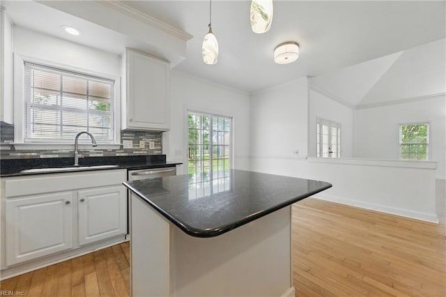 5308 Doral Woods Ct, Suffolk, VA 23435 - kitchen featuring a sink, light wood finished floors, tasteful backsplash, white cabinets, and a center island