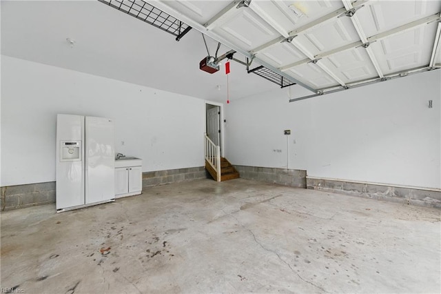 5308 Doral Woods Ct, Suffolk, VA 23435 - garage featuring white fridge with ice dispenser and a garage door opener