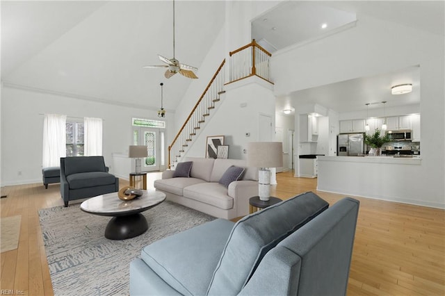 5308 Doral Woods Ct, Suffolk, VA 23435 - living area featuring high vaulted ceiling, stairs, a ceiling fan, and light wood-type flooring