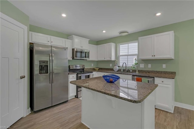6945 Healy Ave, Gloucester, VA 23061 - kitchen featuring stainless steel appliances, light wood finished floors, white cabinetry, dark stone counters, and recessed lighting