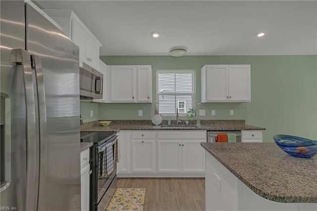 6945 Healy Ave, Gloucester, VA 23061 - kitchen featuring stainless steel appliances, a sink, white cabinetry, and recessed lighting