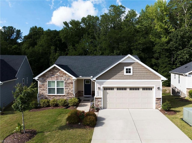 6945 Healy Ave, Gloucester, VA 23061 - craftsman-style house featuring stone siding, driveway, a front lawn, and an attached garage