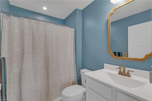 6945 Healy Ave, Gloucester, VA 23061 - full bathroom featuring toilet, vanity, and a shower with curtain