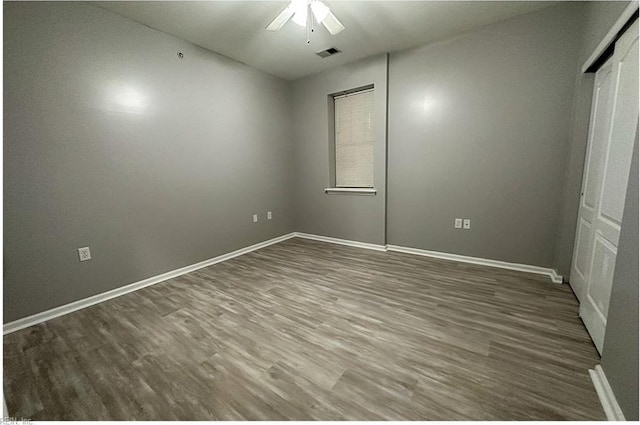 932 Southmoor Dr Unit 105, Virginia Beach, VA 23455 - unfurnished bedroom with wood finished floors, baseboards, a ceiling fan, and a closet