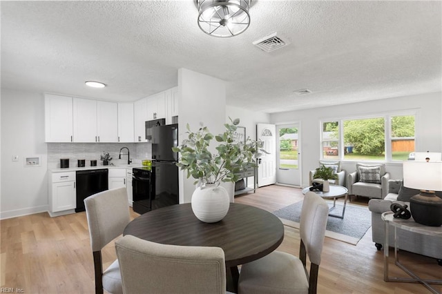 3421 Stancil St, Virginia Beach, VA 23452 - dining area with a textured ceiling, light wood-style flooring, and baseboards