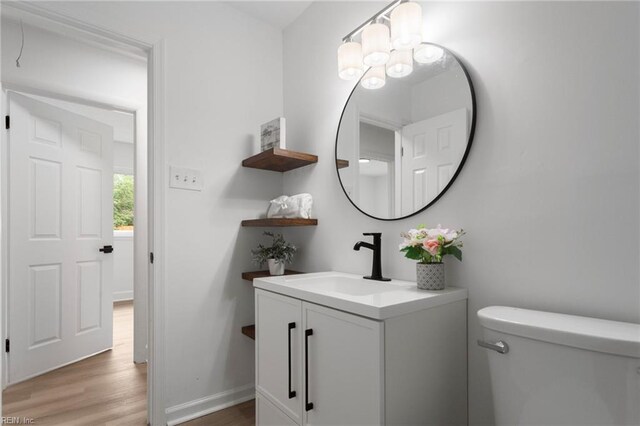 3421 Stancil St, Virginia Beach, VA 23452 - half bath with toilet, vanity, a chandelier, wood finished floors, and baseboards