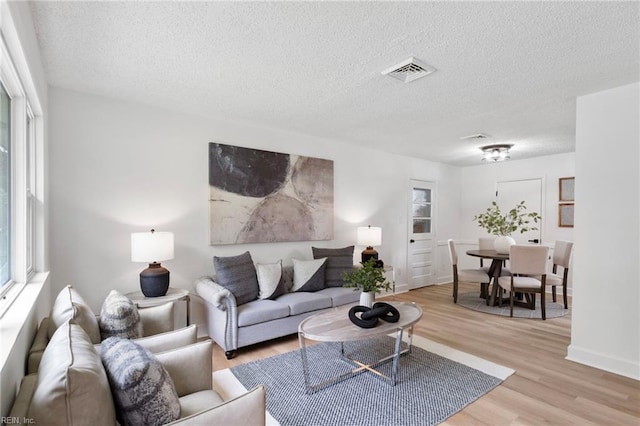 3421 Stancil St, Virginia Beach, VA 23452 - living area with light wood finished floors, a textured ceiling, and baseboards