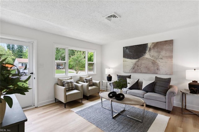 3421 Stancil St, Virginia Beach, VA 23452 - living area with healthy amount of natural light, wood finished floors, a textured ceiling, and baseboards