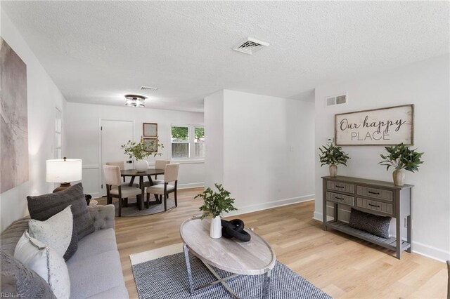 3421 Stancil St, Virginia Beach, VA 23452 - living room with light wood-style flooring, a textured ceiling, and baseboards