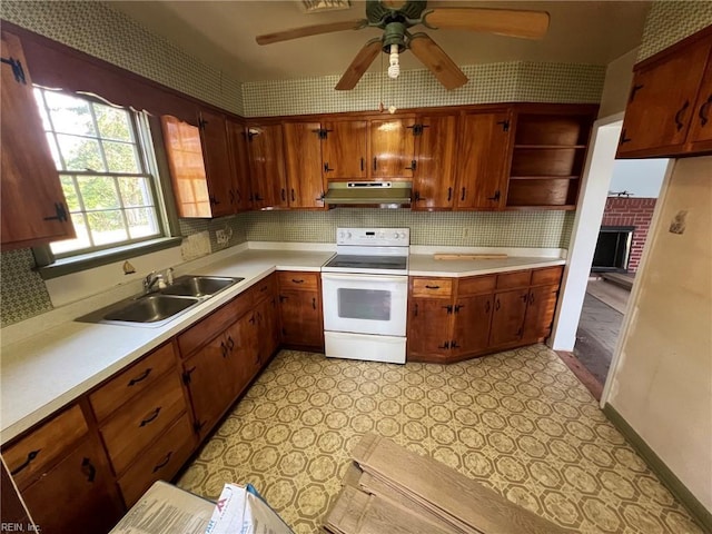 123 Orchard Cove Ln, Callao, VA 22435 - kitchen featuring electric stove, under cabinet range hood, a sink, light countertops, and wallpapered walls