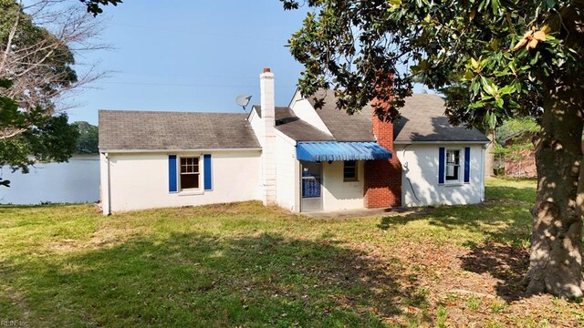 123 Orchard Cove Ln, Callao, VA 22435 - rear view of property with a yard, a chimney, and a shingled roof