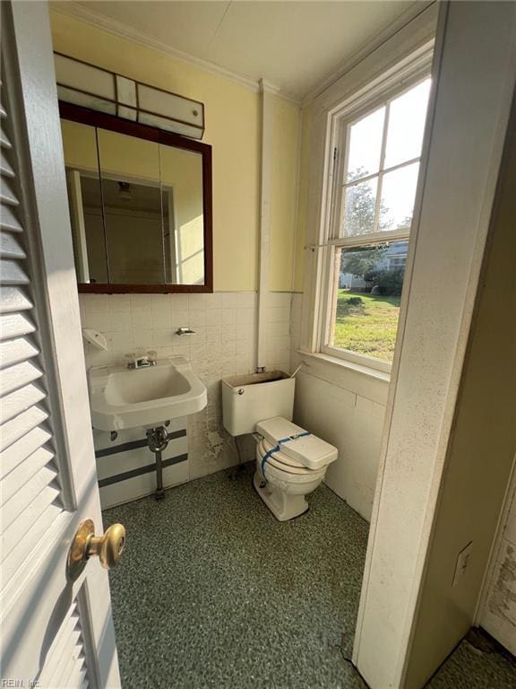 123 Orchard Cove Ln, Callao, VA 22435 - half bath with a sink, toilet, crown molding, wainscoting, and tile walls