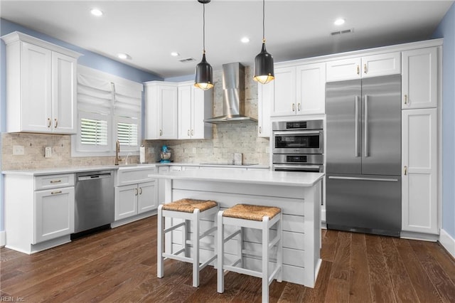 2701 Ashbys Bridge Ct, Virginia Beach, VA 23456 - kitchen featuring stainless steel appliances, wall chimney range hood, light countertops, white cabinetry, and decorative backsplash