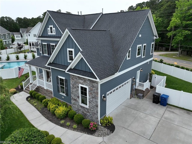 2701 Ashbys Bridge Ct, Virginia Beach, VA 23456 - craftsman inspired home featuring board and batten siding, stone siding, covered porch, a garage, and roof with shingles