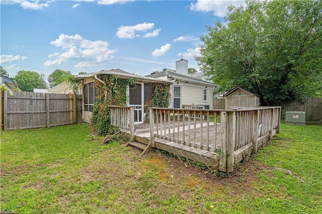 5425 Sweetwater Ct, Virginia Beach, VA 23462 - rear view of house featuring a storage unit, a fenced backyard, a sunroom, a wooden deck, and a chimney