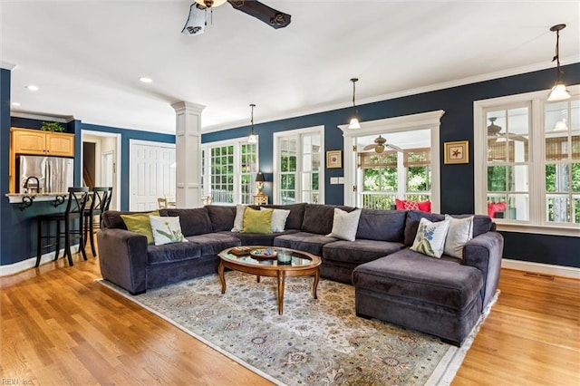 107 Gullane, Williamsburg, VA 23188 - living room with ceiling fan, ornate columns, light wood-type flooring, baseboards, and ornamental molding