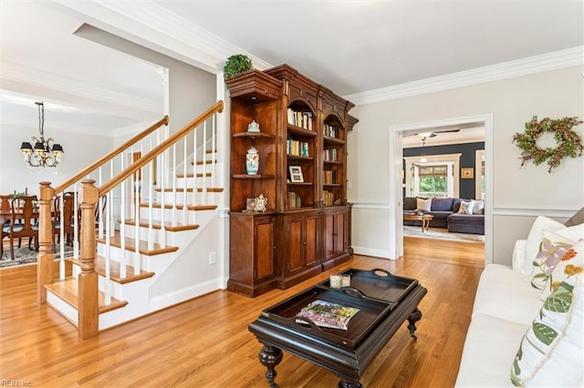 107 Gullane, Williamsburg, VA 23188 - living room with crown molding, stairs, a chandelier, and light wood-style floors