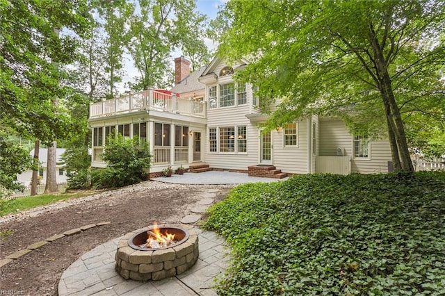 107 Gullane, Williamsburg, VA 23188 - back of house featuring a balcony, a fire pit, a chimney, a sunroom, and entry steps