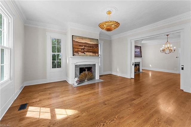 2652 Benefit Rd, Chesapeake, VA 23322 - unfurnished living room featuring a high end fireplace, a chandelier, ornamental molding, and wood finished floors